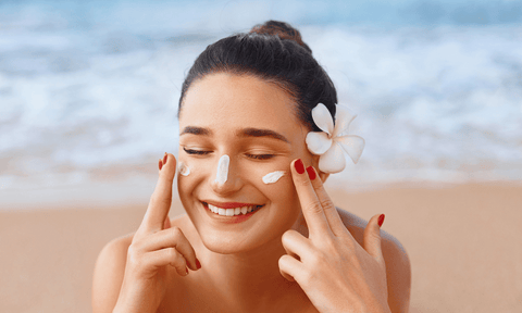 Woman Rubbing Sunscreen on Face
