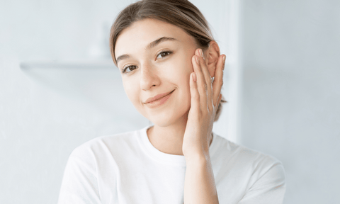 Woman Looking at Skin Under Eyes