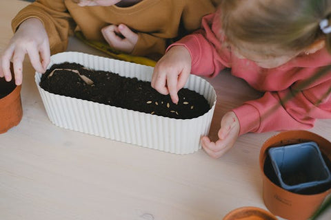 kids planting seeds on ostara