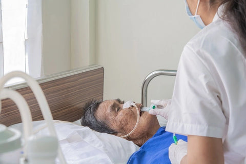 Patients in bed and nurses are preparing to suck up the airways and lungs in the old aged patients