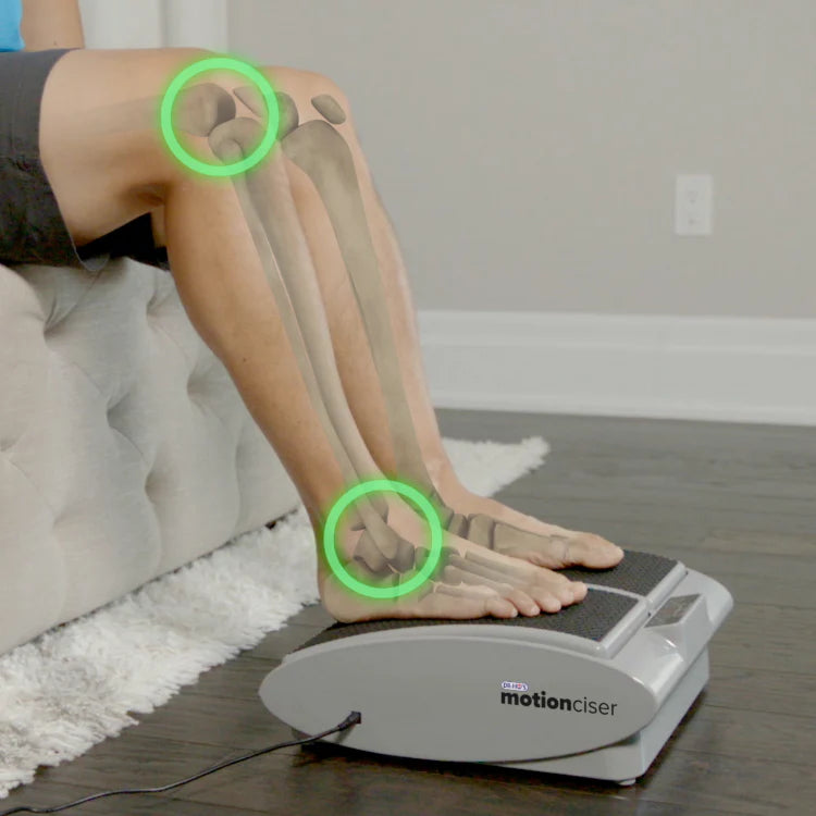 Person using a leg exerciser device with highlighted joints.