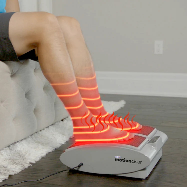 Person using a foot massager with glowing red indicators on socks.