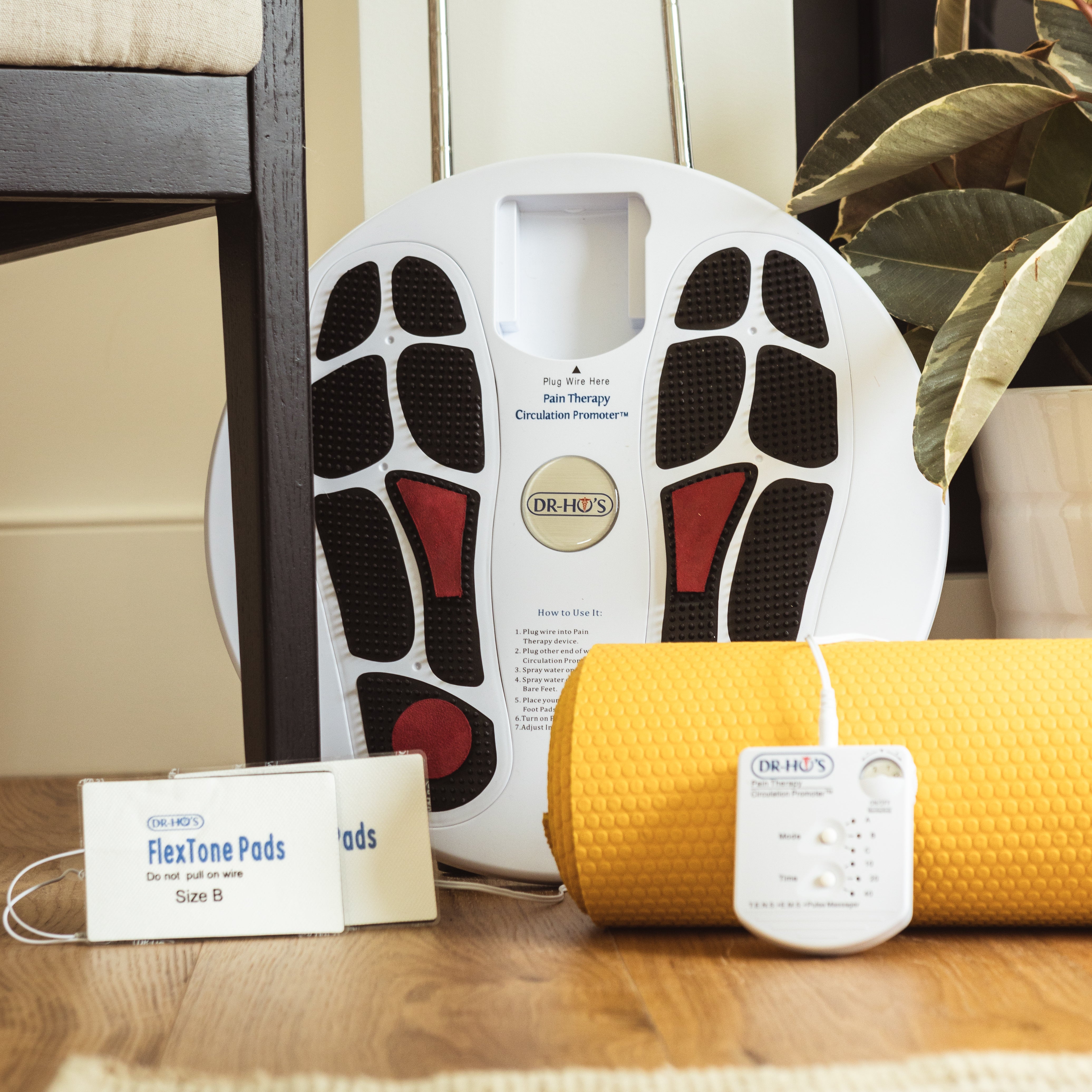 DR-HO'S Circulation Promoter, FlexTone Pads, and other accessories on a wooden floor.