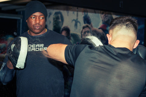 A photo of Barry Robinson holding pads from How to Train for World Level Boxing - Fighter Drills