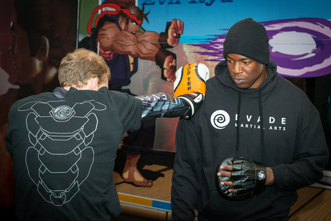 A photo of Barry Robinson holding the pads in his Boxing instructional 'Elite Boxing for Combat Sports - Mastering Agility'