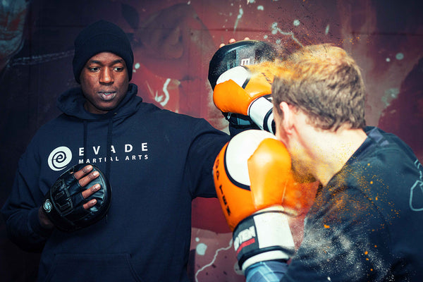 A photo of Barry Robinson holding pads demonstrating the A Million Styles Boxing System