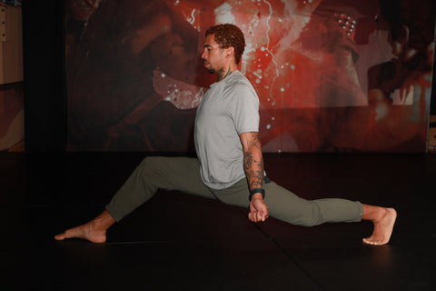 A photo of Cameron demonstrating how to kick higher through flexibility for Martial Arts Stretches