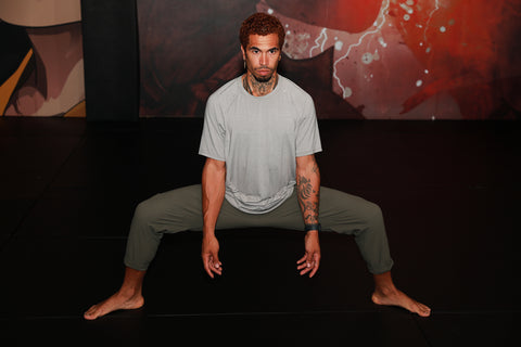 A photo of Cameron demonstrating how to kick higher through flexibility for Martial Arts Stretches