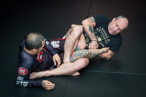 A photo of leg locks in action from the Combat Base Darren and Helen Currie BJJ volume Simplifying Leg Locks