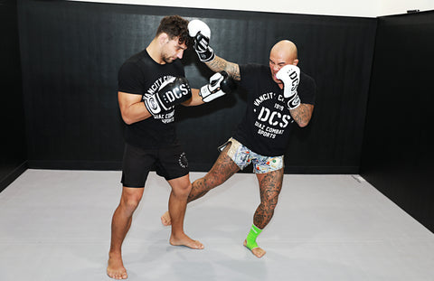 A photo of Ryan Diaz showing a calf kick from his MMA Striking Drills volume