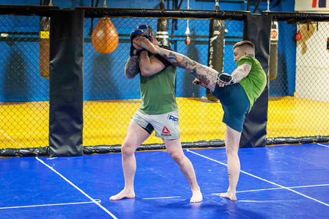 A photo of two higher level mma fighters demonstrating mma drills for elite level fighters and chaining attacks with James Doolan