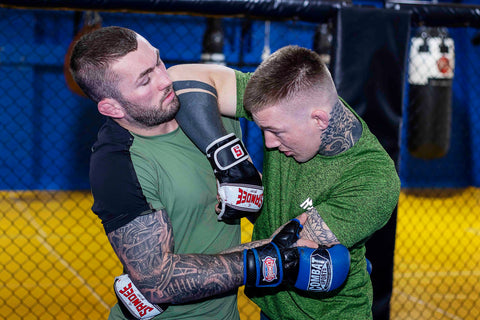 A photo of two higher level mma fighters demonstrating mma drills for elite level fighters and chaining attacks with James Doolan