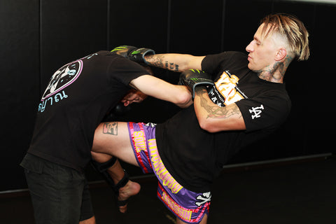 A photo of Kevin Ross using the art of 8 limbs in Muay Thai fighting