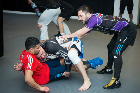 A photo of a coach helping athletes from the blog post about Mental Skills Training for Fighters in Martial Arts and Combat Sports