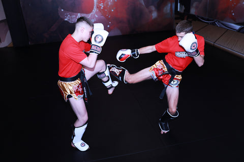A photo of two fighters showcasing how to fight with advanced Kickboxing Drills