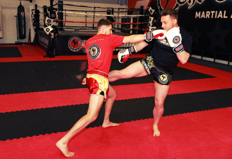 A photo of Mick Crossland demonstrating kickboxing sparring drills for developing fighters
