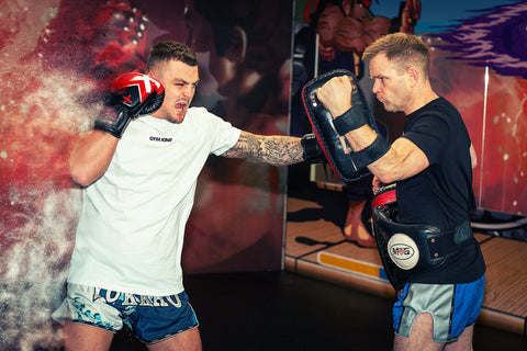 A photo of Richard Smith from Muay Thai 101 - A Framework for Developing Fighters as he holds the pads in training