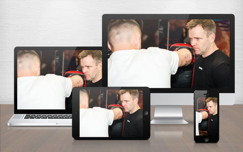 A graphic image of Richard Smith from Muay Thai 101 - A Framework for Developing Fighters as he holds the pads in training
