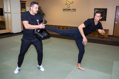 A photo of Steven Lopez demonstrating part of his superhuman kicking system in Taekwondo for Combat Sports.