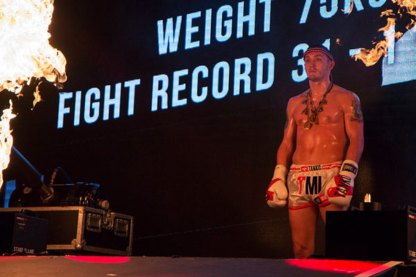 A photo of a fighter approaching the ring from the blog post covering how to cope with pressure and performance anxiety in combat sports