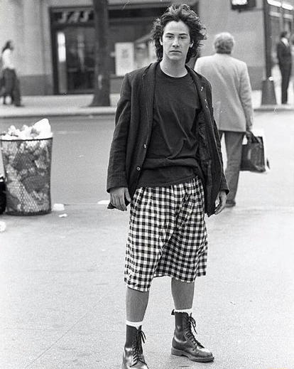 Keanu Reeves in Toronto, Ontario, in black suit jacket and plaid skirt.