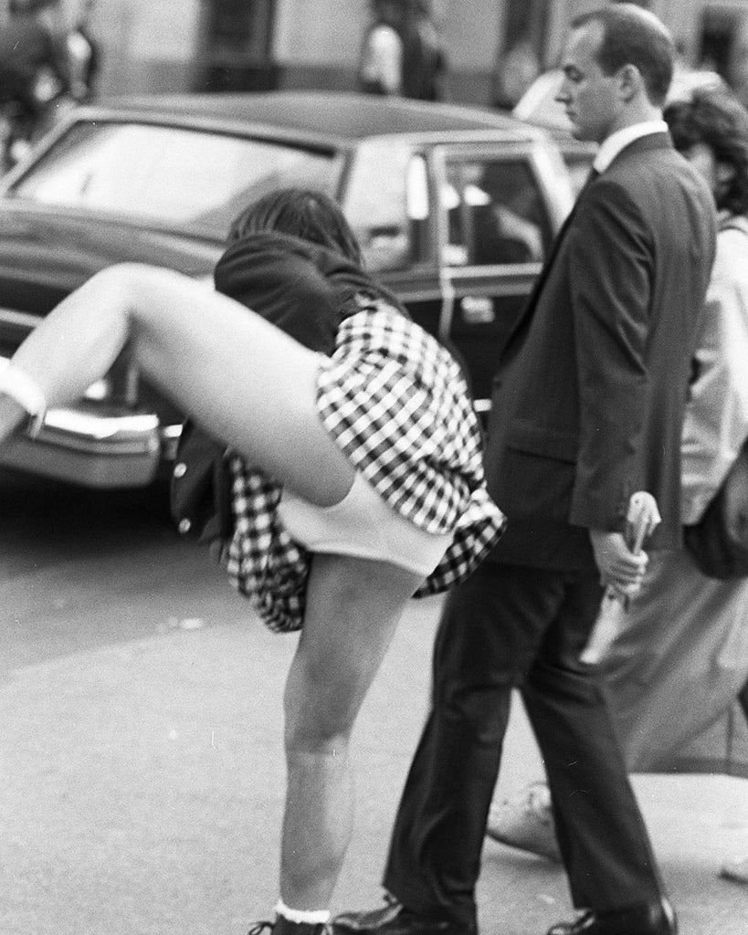 Keanu Reeves in Toronto, Ontario, at a crosswalk, in black suit jacket and plaid skirt lifted up around his back, so you could see his white underwear.