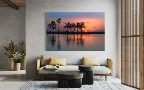 Sunrise over the ocean with palm tree and orange horizon