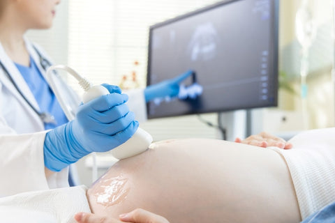 woman performing regular fetus check