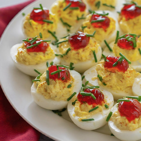 Picture of Deviled Eggs with a dollup of Devil's Fire Wine Jelly sitting on top of the egg yolk filling