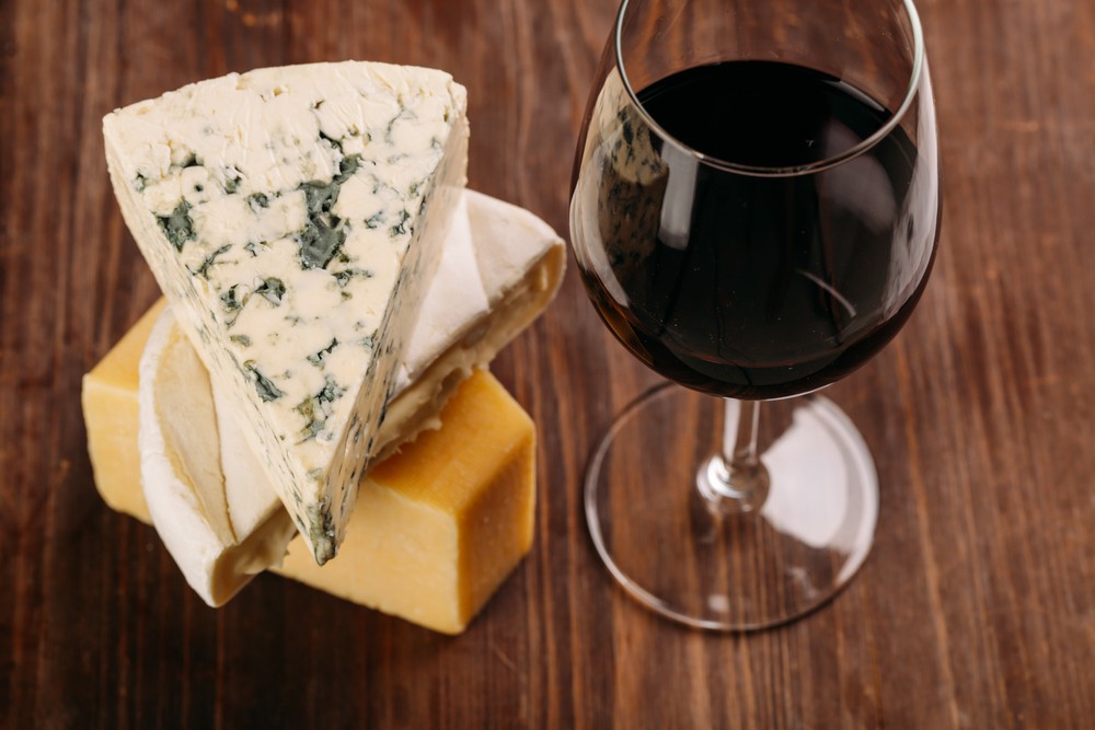 wine teeth - glass of wine and cheese on a wooden table