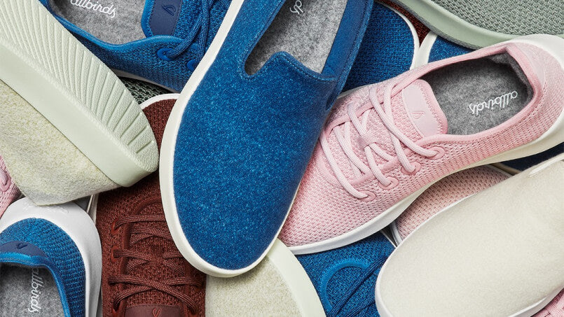 Pile of Allbirds shoes in various colours