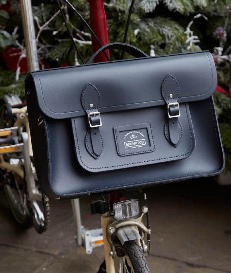 A black satchel is affixed to the front of a bike.