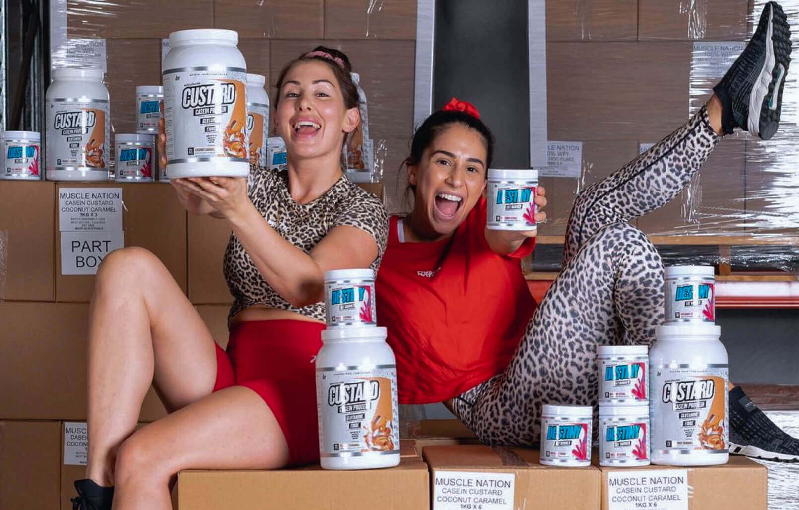 A couple of content Muscle Nation customers posing with some Muscle Nation protein inventory.