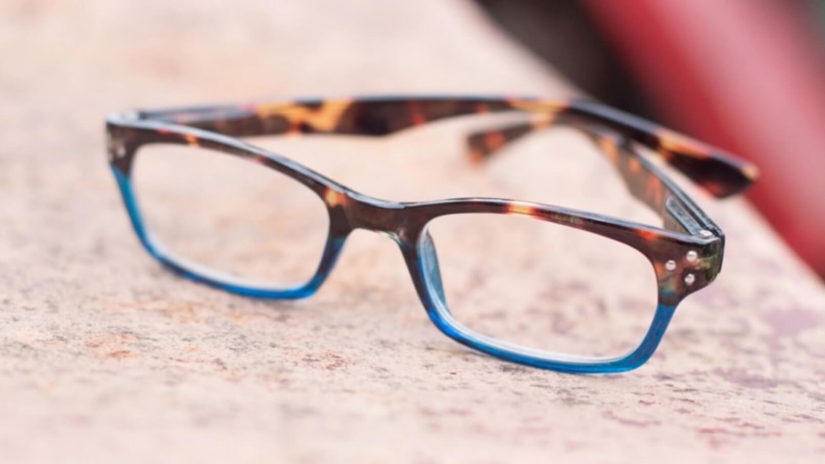 A pair of Peeper's glasses, with brown, tortoise shell frames that fade to a deep sky blue.