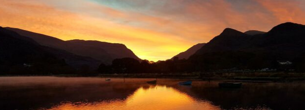 Early morning scenes on a still Llyn Padarn in winter