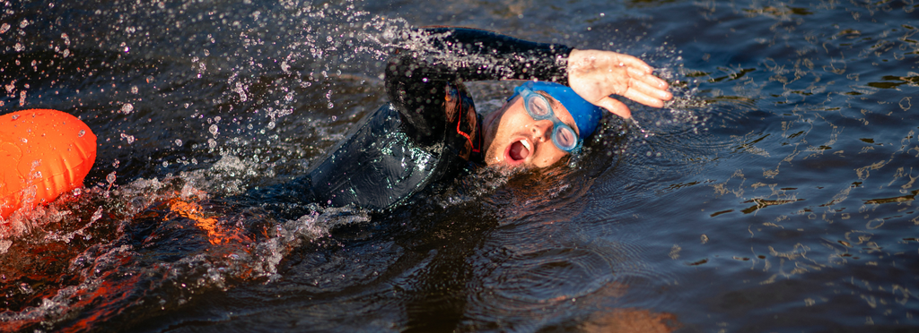 Swimmer in a wetsuit with float