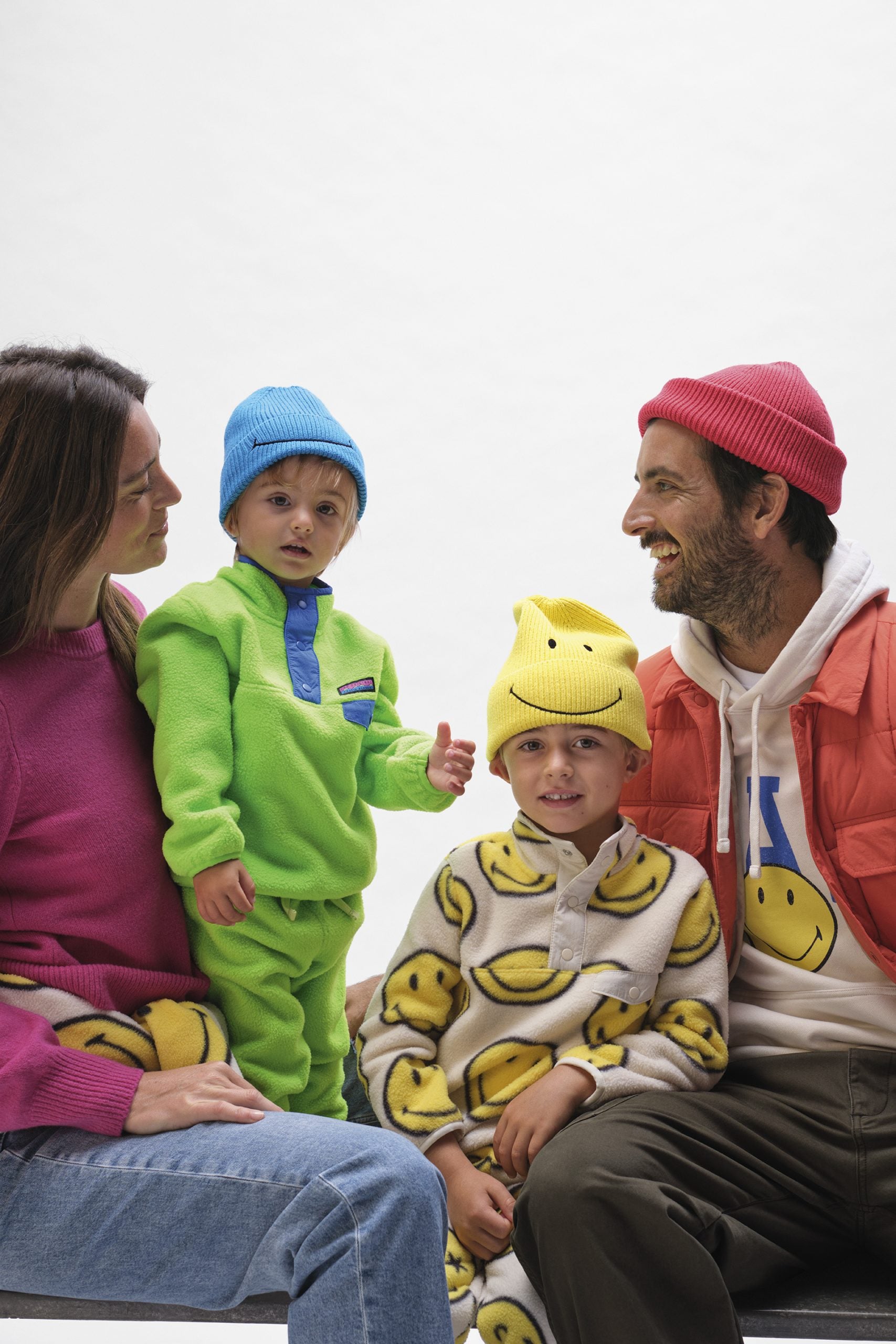 A family wearing clothing from the Gap x Smiley collaboration.