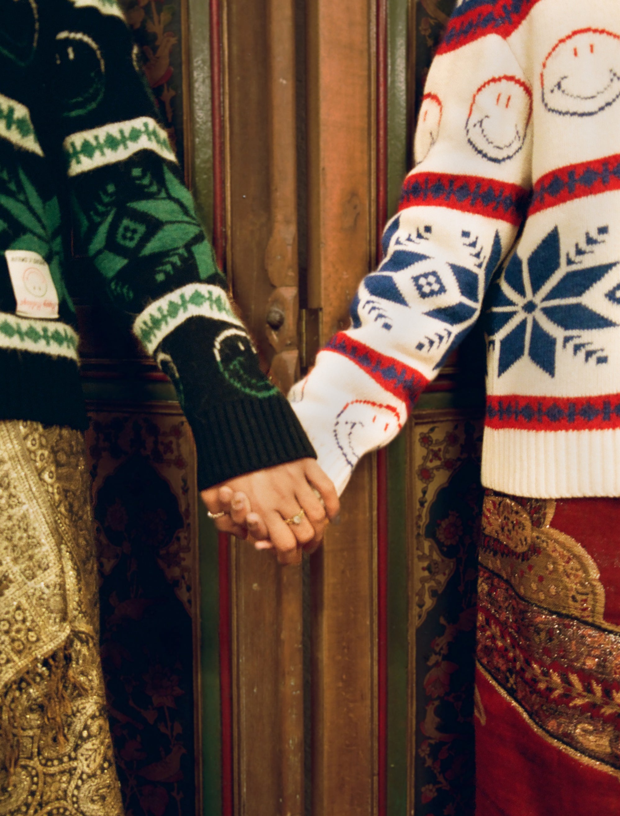 Nael and Zain, holding hands, in Sandro & Smiley jumpers.