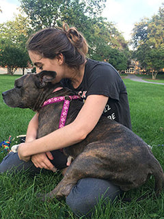 Woman snuggling with a dog