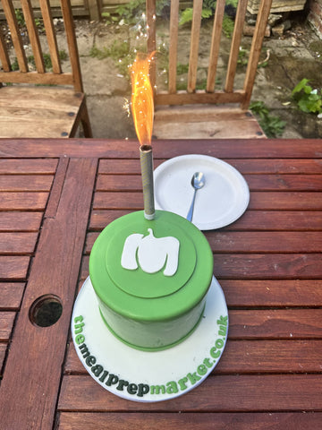Image with the celebratory The Meal Prep Market branded cake