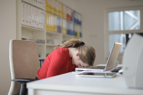 Benefits of Sleep: Sleepy Woman Sleeping on a Laptop