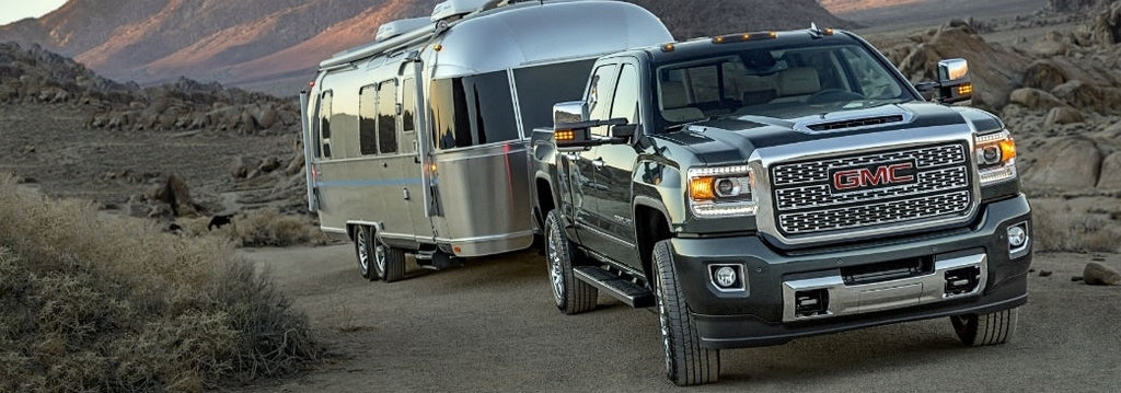GMC Truck with Rubber Springs towing Airstream Camper