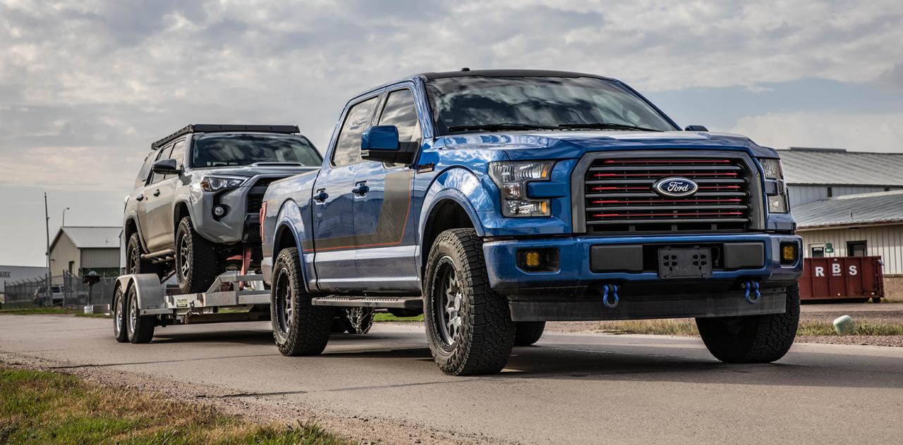 Lifted Ford F150 towing an SUV