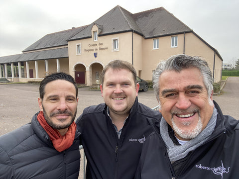 Matt, Roberto Cipresso, and Marco smiling in front of a winery