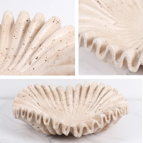 A composite image shows three views of a textured, off-white decorative bowl with prominent vertical ridges and a wavy rim. The bottom view shows the full bowl, while the top two views offer close-ups of the textured surface and scalloped edge. The bowl appears to be made of a porous, stone-like material.