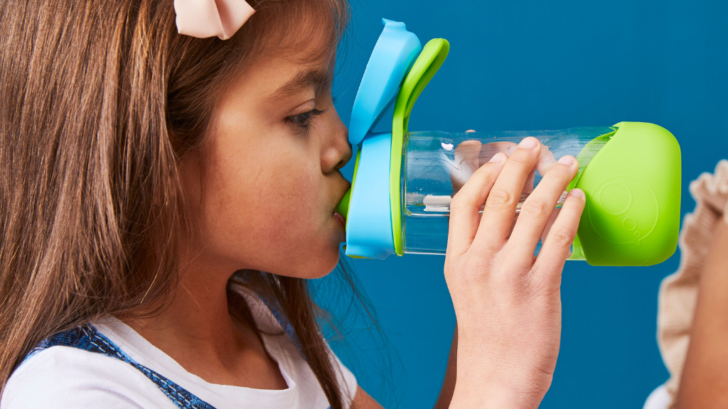 child using b.box sport spout 450ml water bottle for drinking