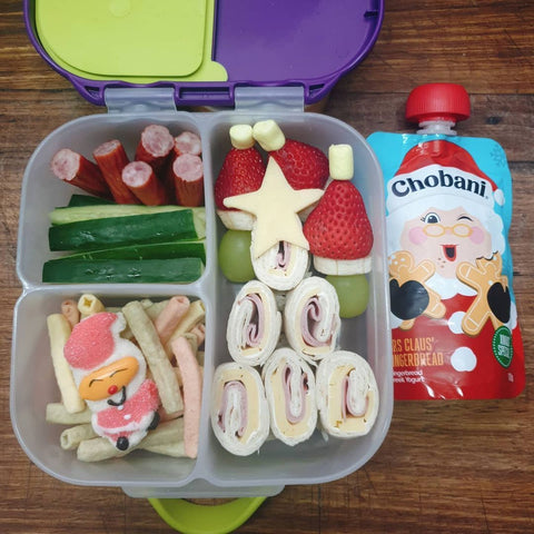 a b.box mini lunchbox featuring pinwheel sandwiches shaped like a Christmas tree, with veggie straws, meat sticks, and fruit on a stick