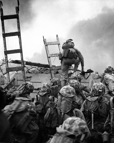 First Lieutenant Baldomero Lopez, USMC, leads the 3rd Platoon, Company A, 1st Battalion, 5th Marines over the seawall on the northern side of Red Beach