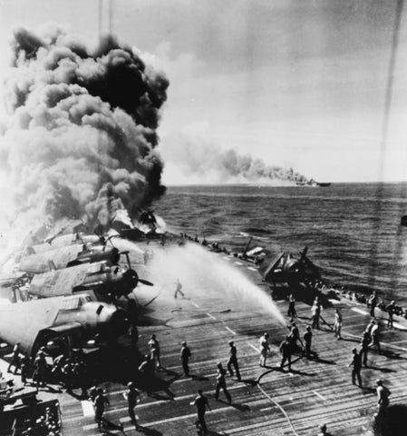 Belleau Wood burning after she was hit by a kamikaze in the Philippines, 30 October 1944. In the background is the burning Franklin, also hit by the Japanese.