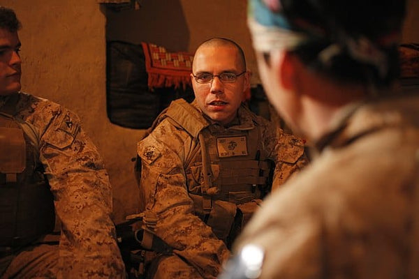 U.S. Marines with Police Advisory Team 1, 1st Battalion, 8th Marine Regiment, Regimental Combat Team 6 speak with an Afghan National Civil Order Police commander in Kajaki, Afghanistan, Feb. 15, 2012